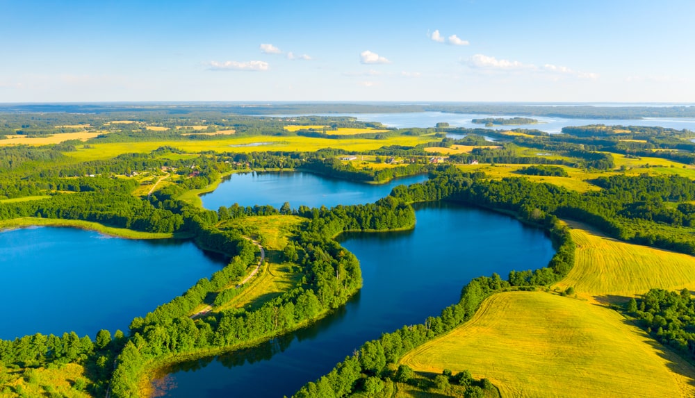 Aerial view of Narach Lakes in Belarus, featuring clear waters and vibrant green landscapes, perfect for hiking along scenic routes in the region.