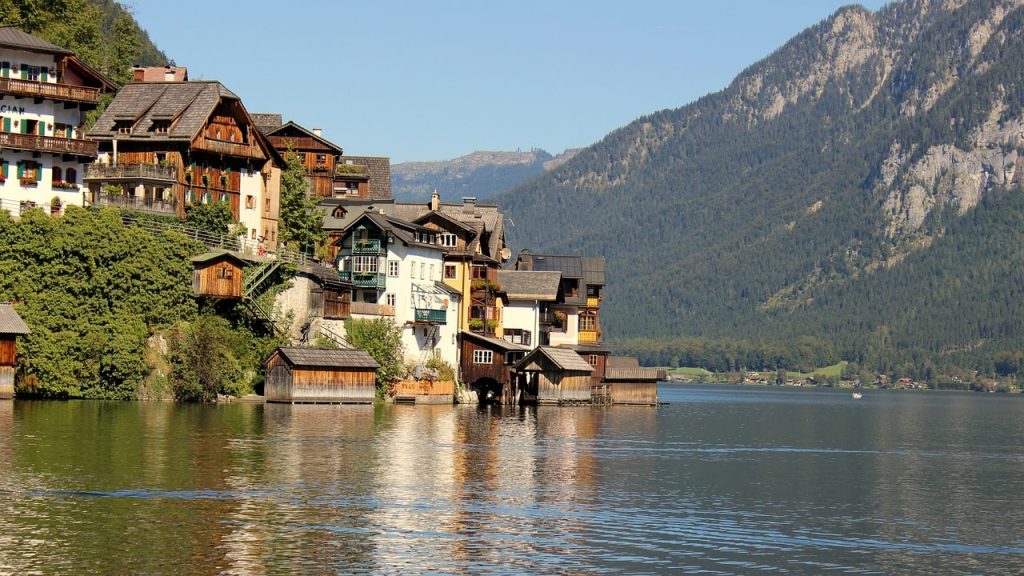 Charming lakeside houses in the Salzkammergut Region, a must-visit destination for Austria walking tours with stunning alpine views.