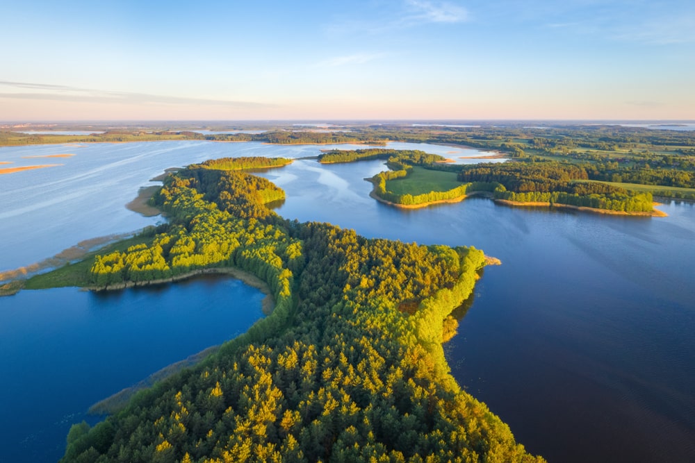 A breathtaking aerial view of Braslav Lakes, with winding waterways and dense forests, offering ideal landscapes for hiking trails in Belarus.