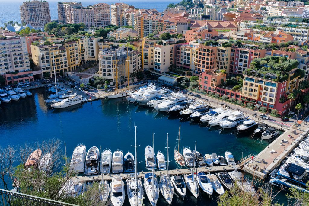 A scenic view of Port Hercules in Monaco with luxury yachts along the promenade, perfect for exploring hiking trails in Monaco's beautiful coastal landscapes.