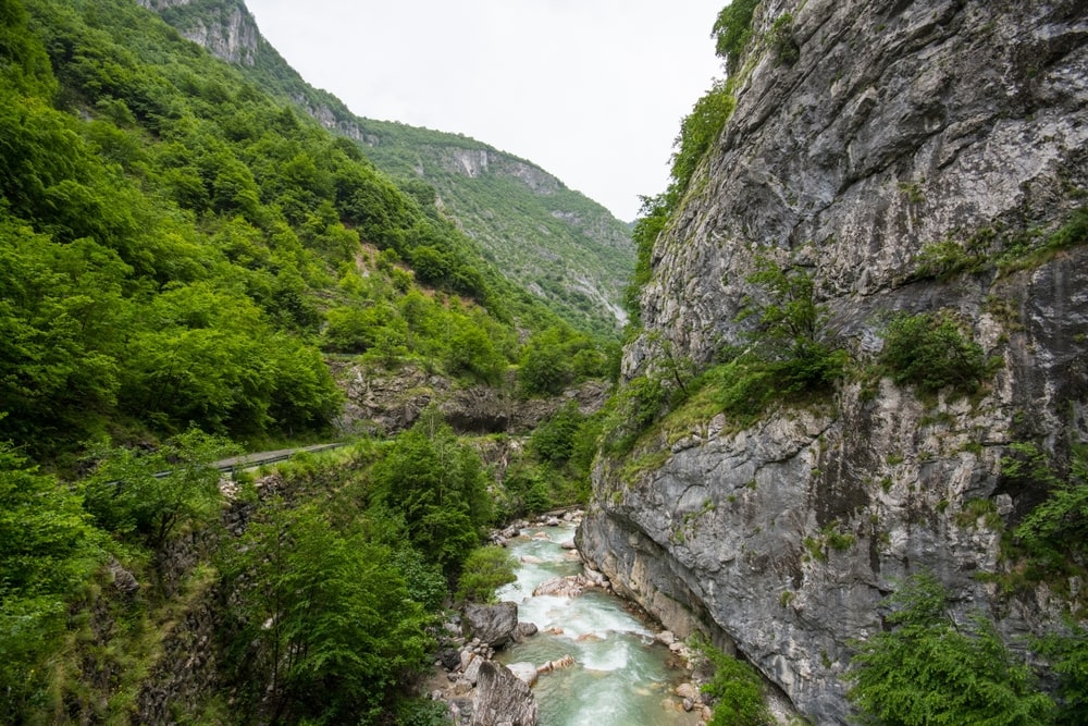 Rugova Canyon in the Kosovo mountains, showcasing stunning natural landscapes with steep cliffs, lush greenery, and a flowing river.