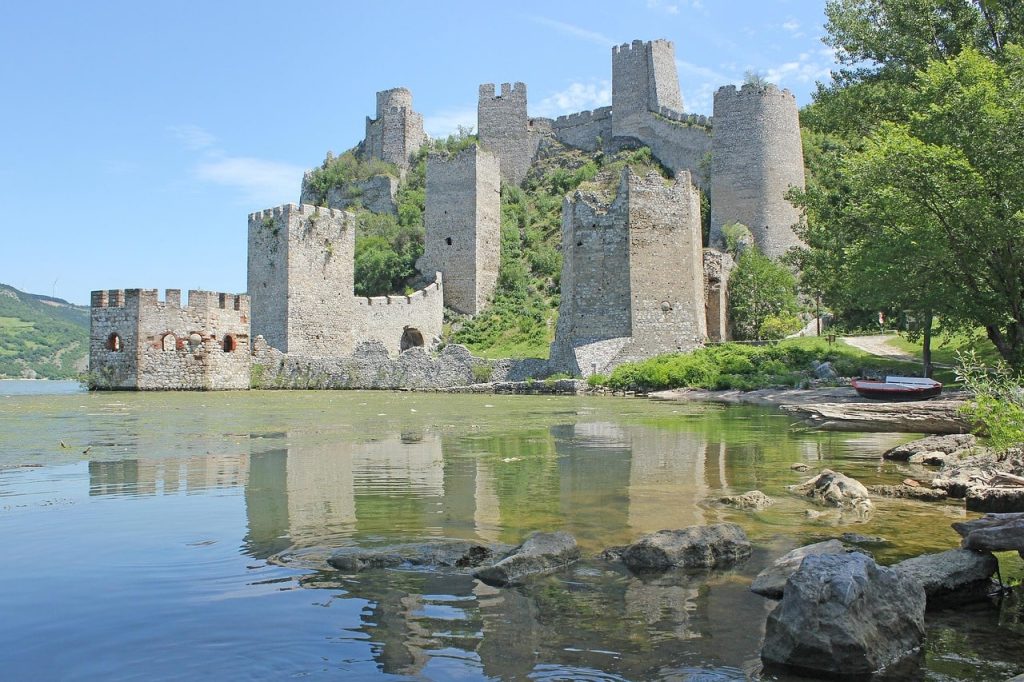 The ruins of a castle beside the river in Đerdap National Park, a perfect location for outdoor adventures in Serbia.