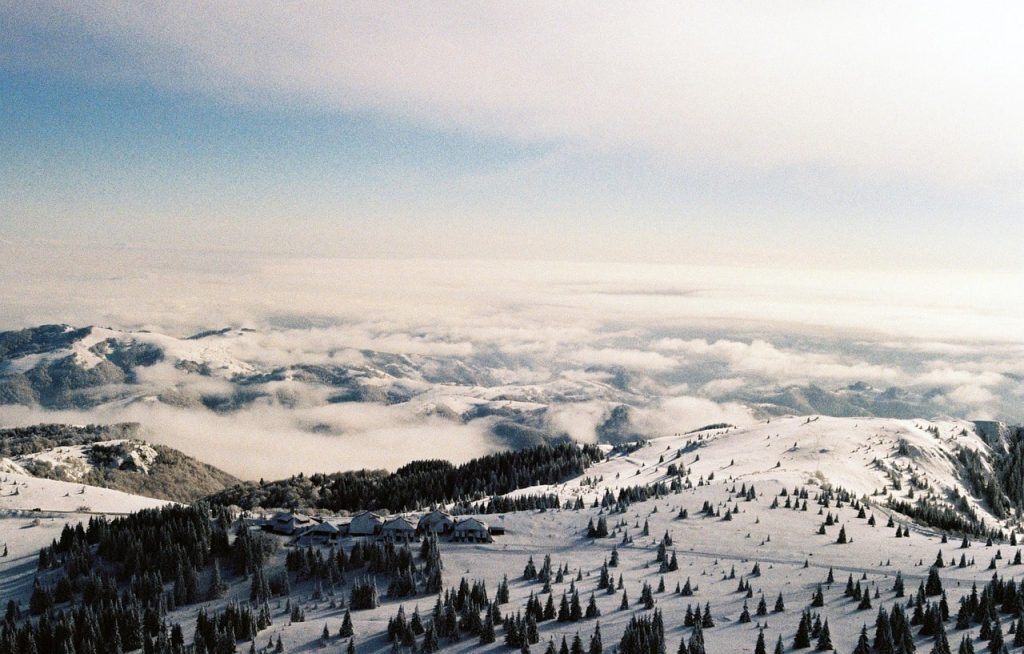 Snow-covered hills and trees with mountain peaks in Kopaonik National Park, a top destination for hiking trails in Serbia.