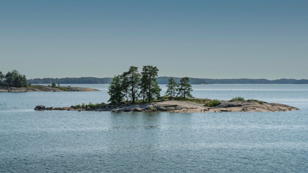 Scenic rocky island with pine trees in the Finnish archipelago, a perfect spot for outdoor adventures Finland travelers love to explore.
