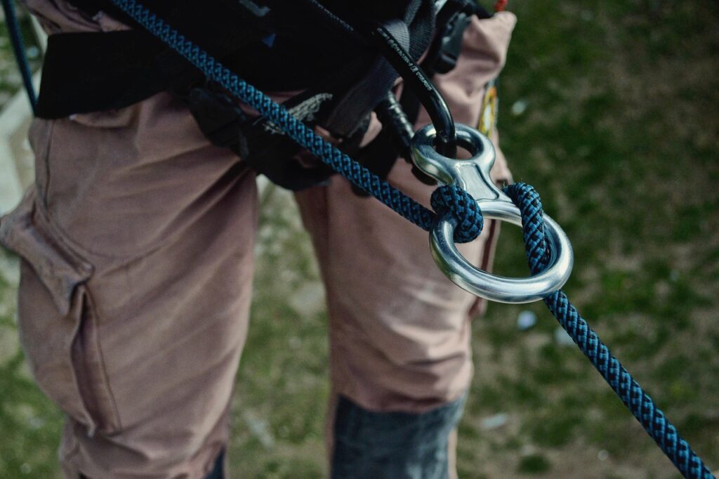 Close-up of climbing rope and harness attachment, essential item on a backpacking gear list
