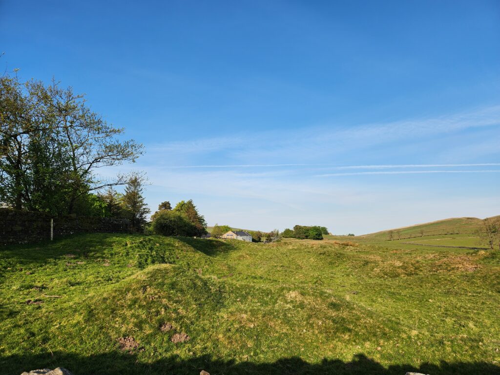 Once Brewed to Walton 1 Kayde Parker Wide open countryside with green field trees on the left and a clear blue sky with faint contrails