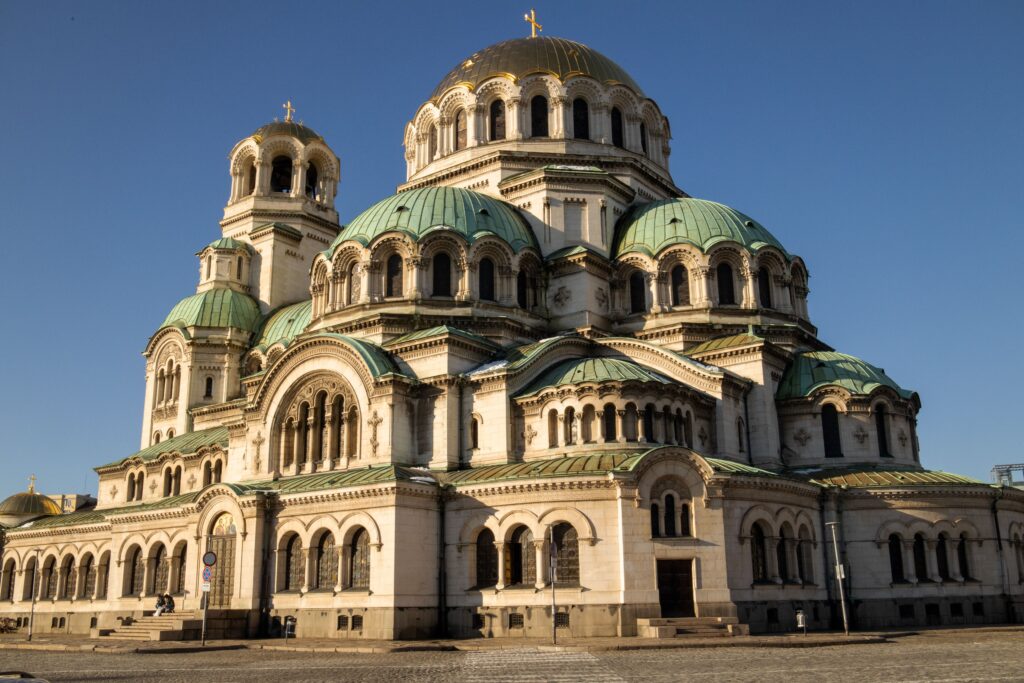 Alexander Nevsky Cathedral in Sofia with iconic domes and grand architecture under a clear blue sky.