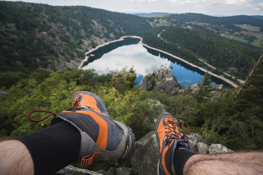 Fit Sizing  Comfort Tips for hiking footwear featuring trail shoes with scenic mountain views on a hiking route