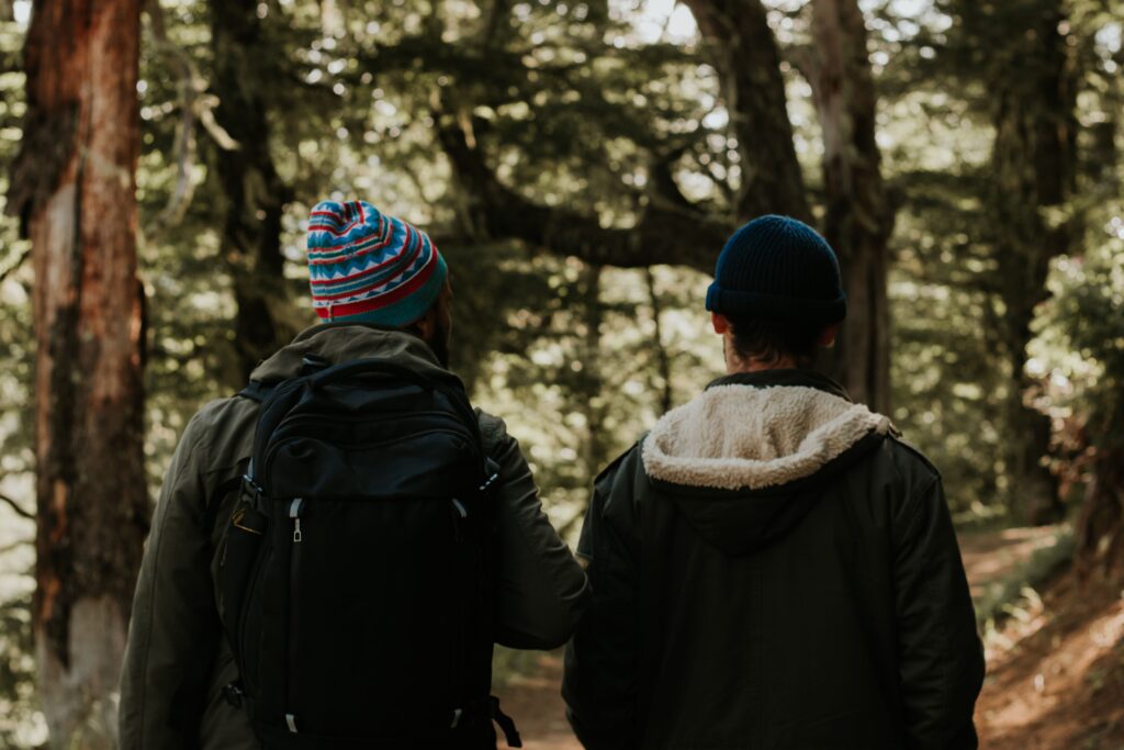Comparison of Merino Wool vs Synthetic Base Layers for hiking, highlighting comfort, warmth, and moisture control.