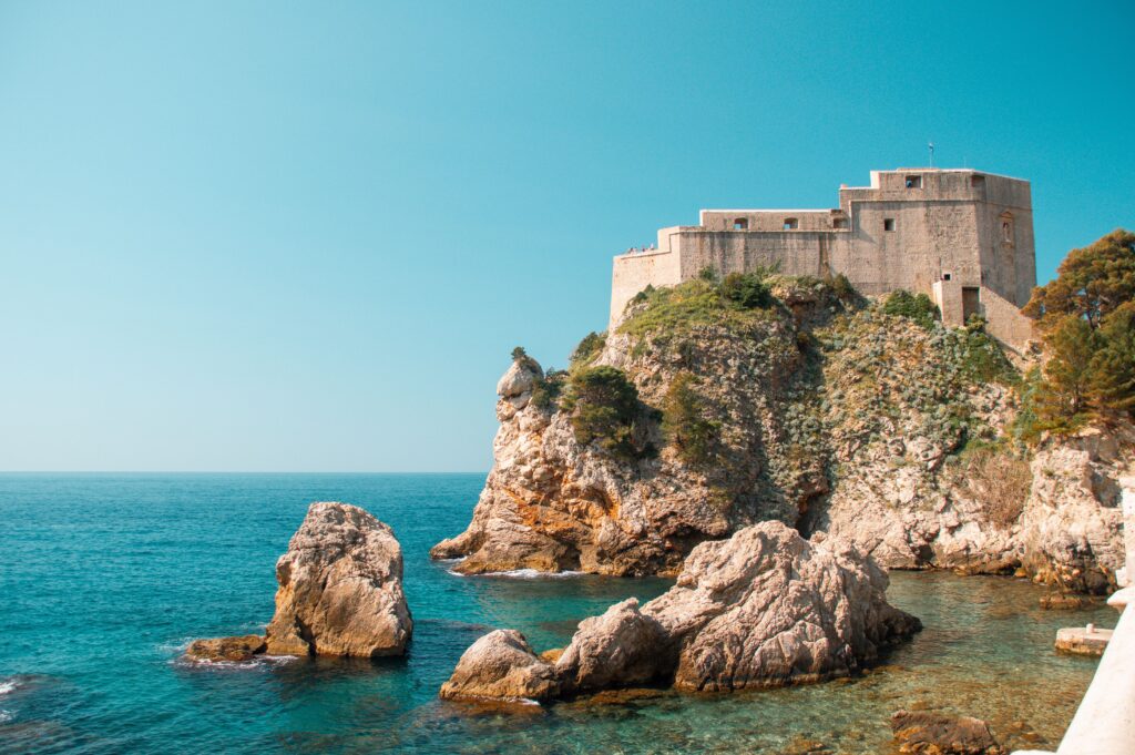 Trails Views and Hidden Gems Near the Adriatic rocky coastline turquoise sea and historic fortress overlooking the shore