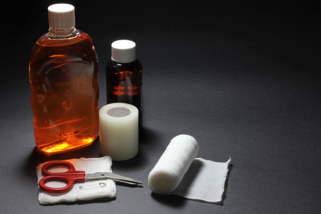 First Aid & Blister Care at a Glance with bandages, antiseptic, scissors, and medical supplies for hiking.