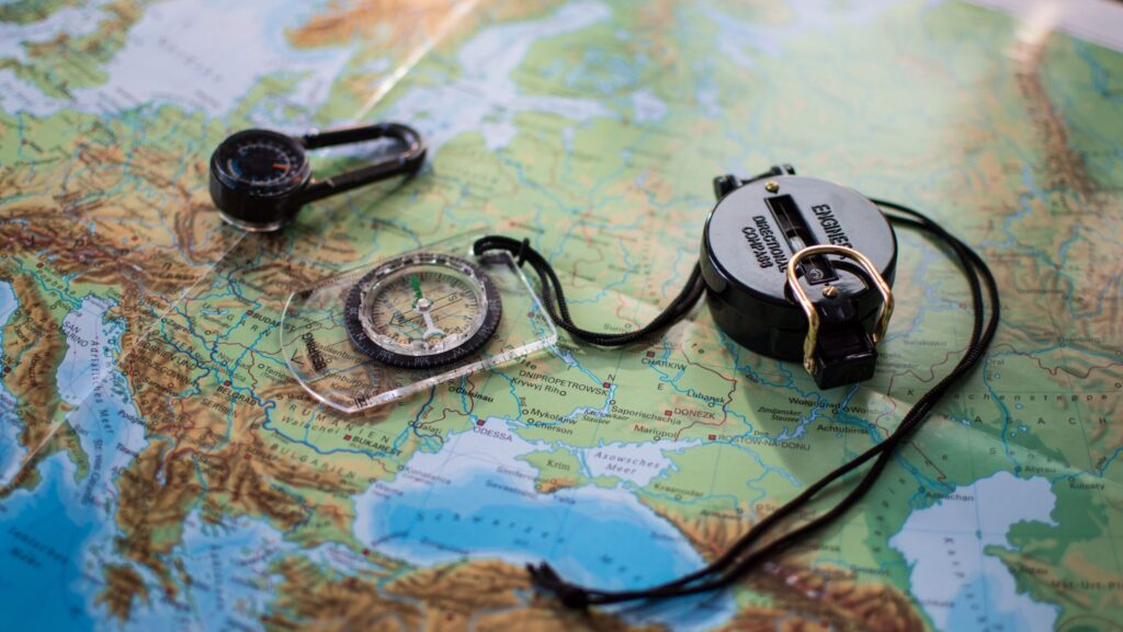 maps-and-navigation Maps and navigation tools including compasses and a topographic map for safe hiking route planning and outdoor adventures.