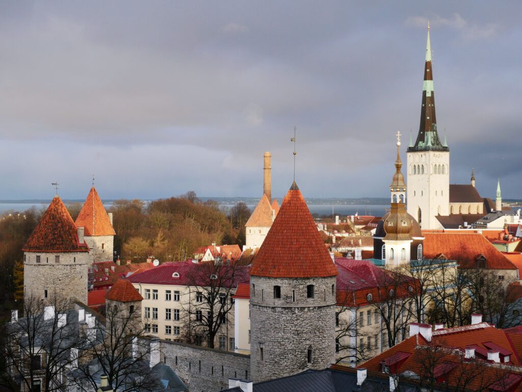 6 of the Very Best Hikes To Do in Tallinn Kayde Parker Tallinn Old Town rooftops and historic towers overlooking the Baltic Sea | Best Hikes in Tallinn