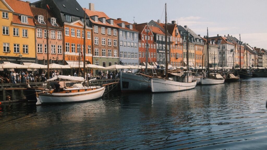 Best Copenhagen Hikes with colourful waterfront buildings and boats along Copenhagens Nyhavn harbour