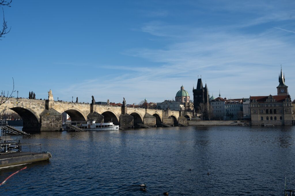 Charles Bridge Prague spanning the Vltava River with historic towers and Old Town skyline