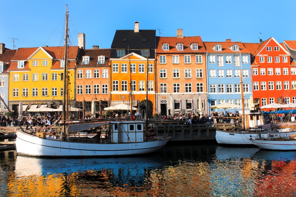 Nyhavncopenhagen Kayde Parker Colourful waterfront buildings and boats along Nyhavn canal in Copenhagen