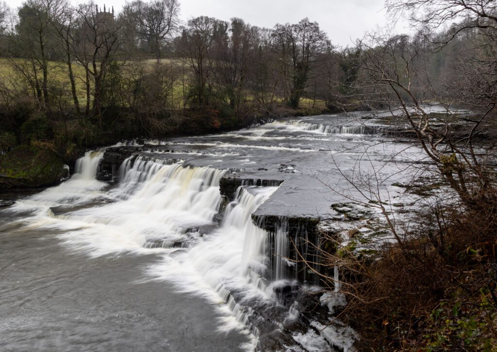 Aysgarth Falls Yorkshire England with cascading waterfalls over rocky river steps