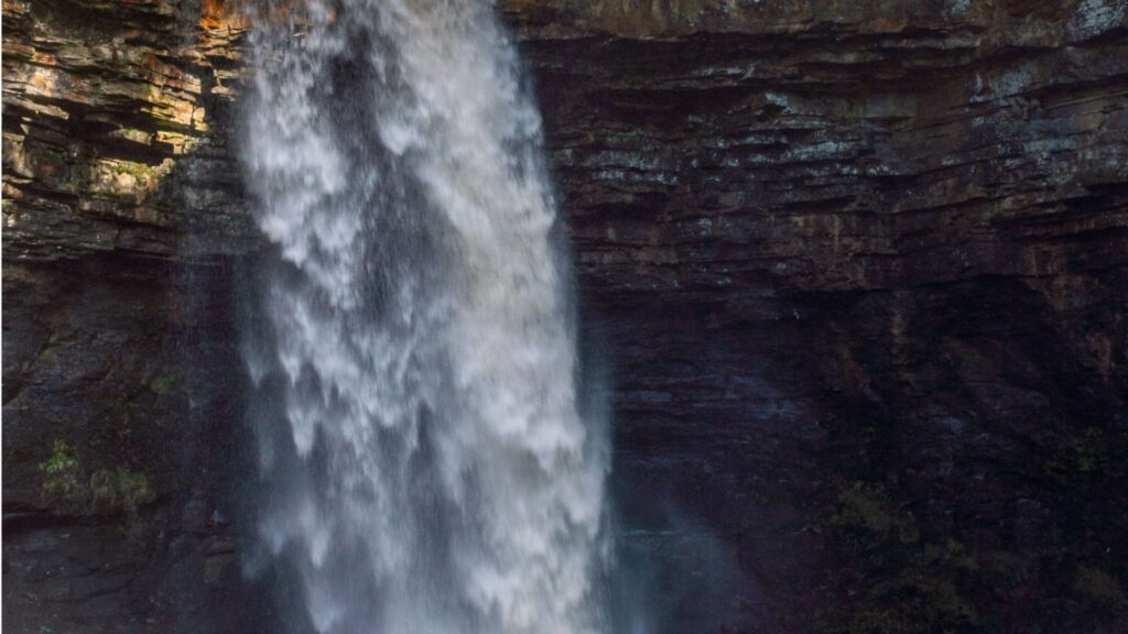 Best Waterfall Hikes in Yorkshire England with cascading waterfall through rocky cliffs