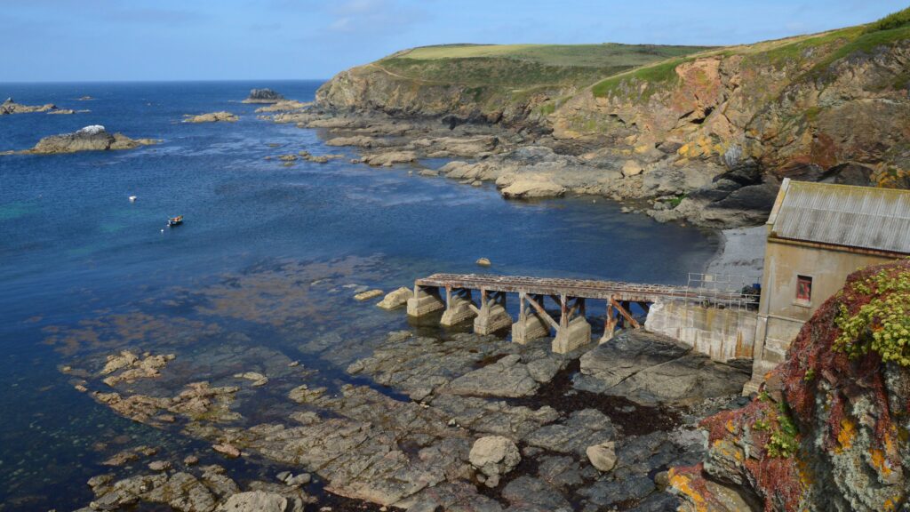 Lizard Peninsula Circular coastal trail with rocky cliffs clear blue sea and rugged Cornish coastline