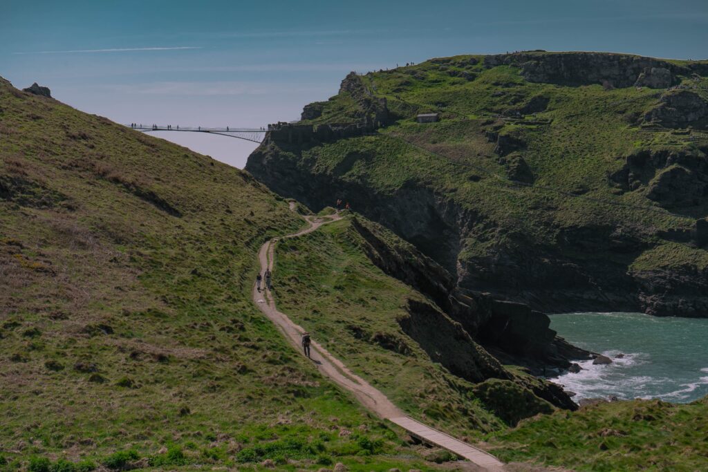 Tintagle England coastal hiking trail with rugged cliffs green hills and ocean views