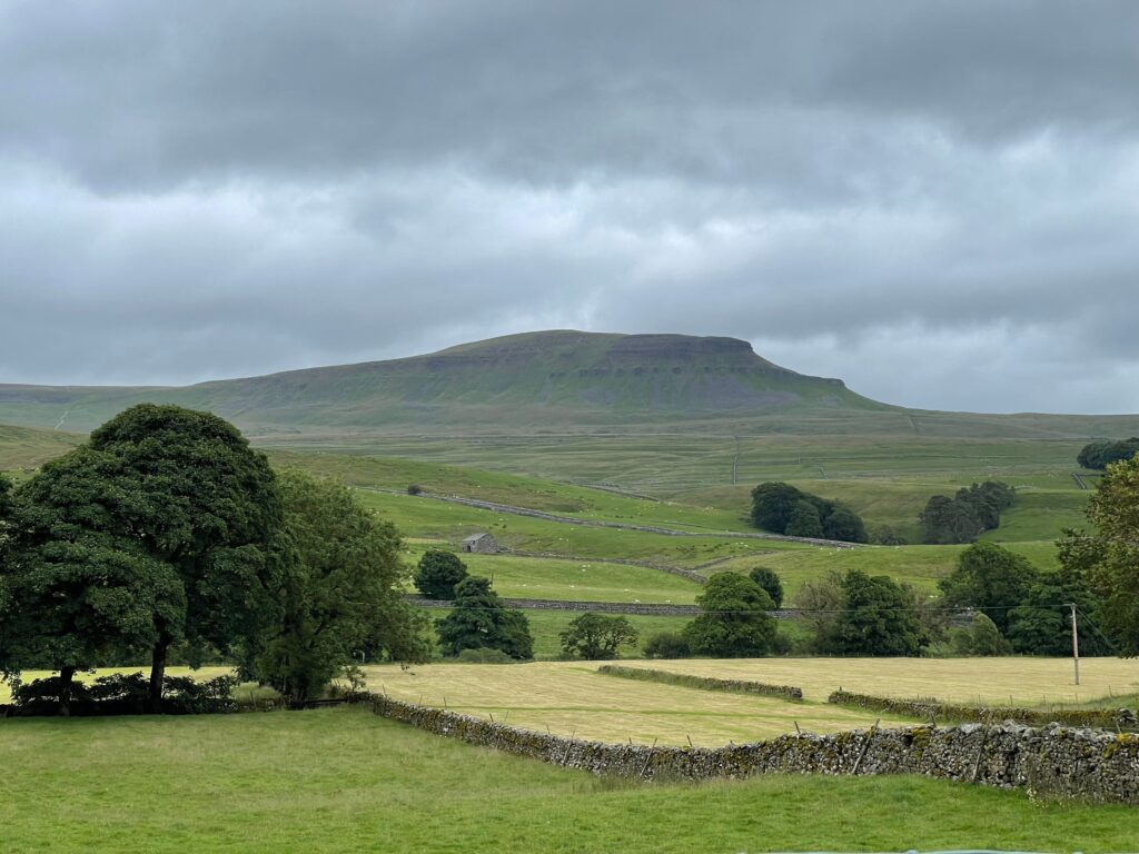 WhernsideYorkshireDales Kayde Parker Whernside Yorkshire Dales landscape with rolling green hills stone walls and scenic countryside