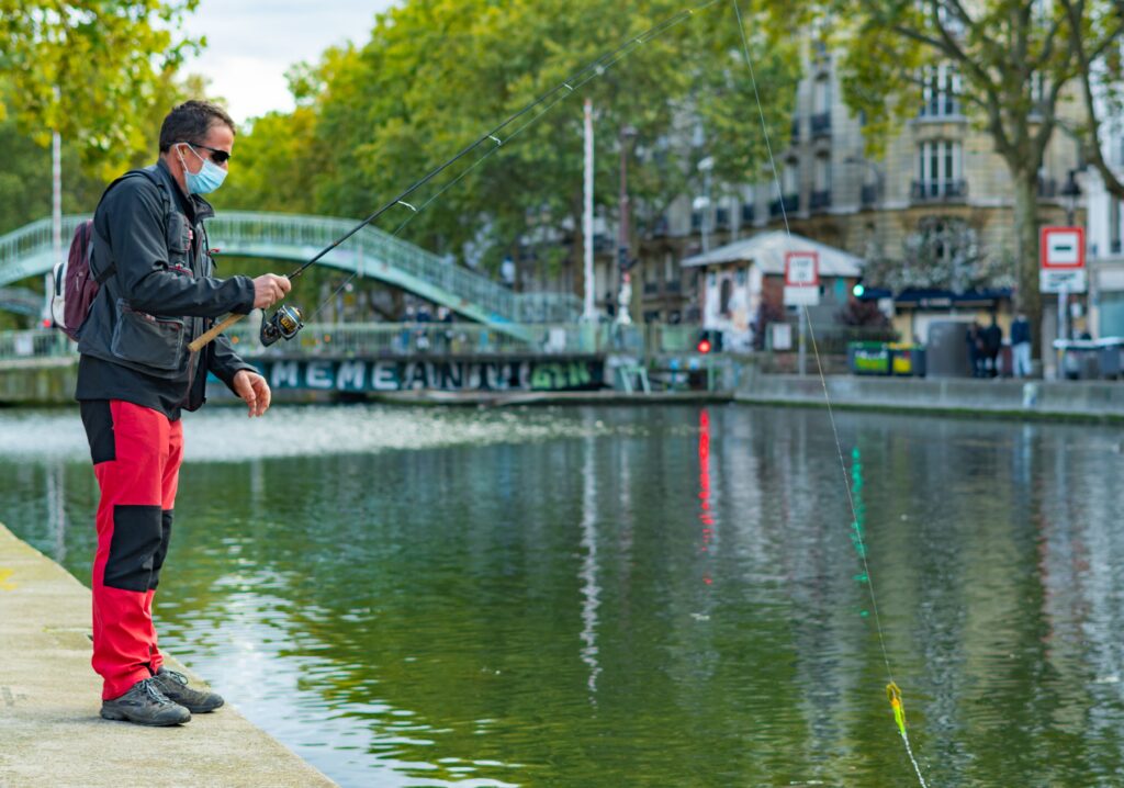 Canal Saint Martin to Parc de la Villette with a fisherman by the water in Paris