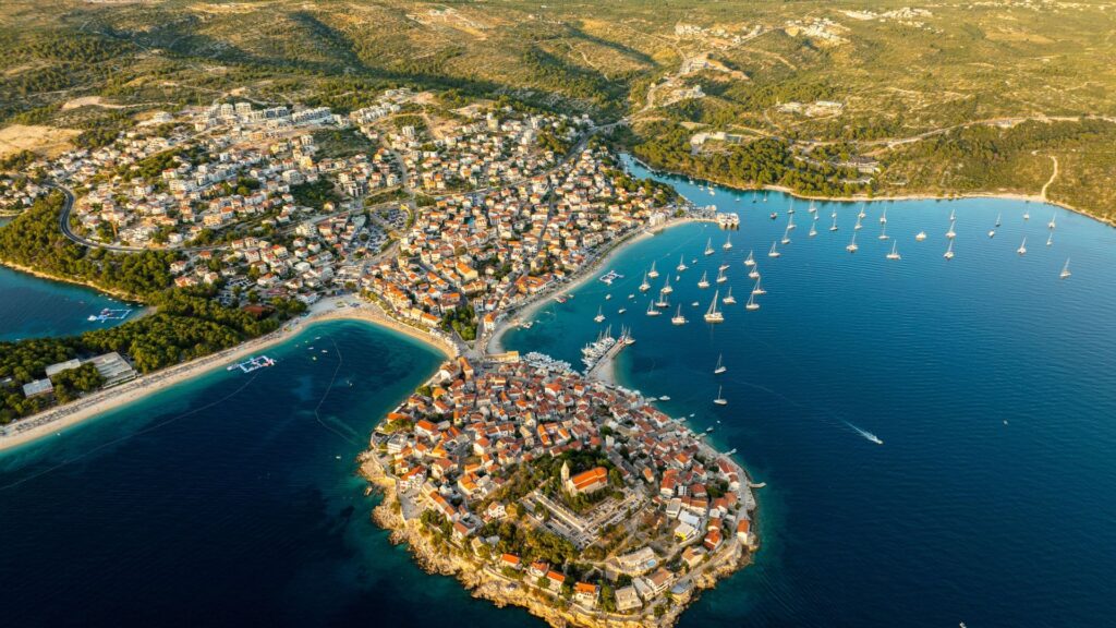Hiking the Dalmation Coast with an aerial view of a scenic Croatian coastal town and turquoise bays
