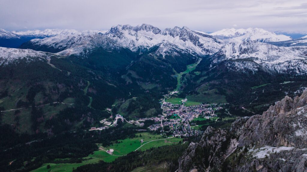 San Martino di Castrozza italy Kayde Parker Aerial view of the mountain town and snowy peaks surrounding San Martino di Castrozza Italy