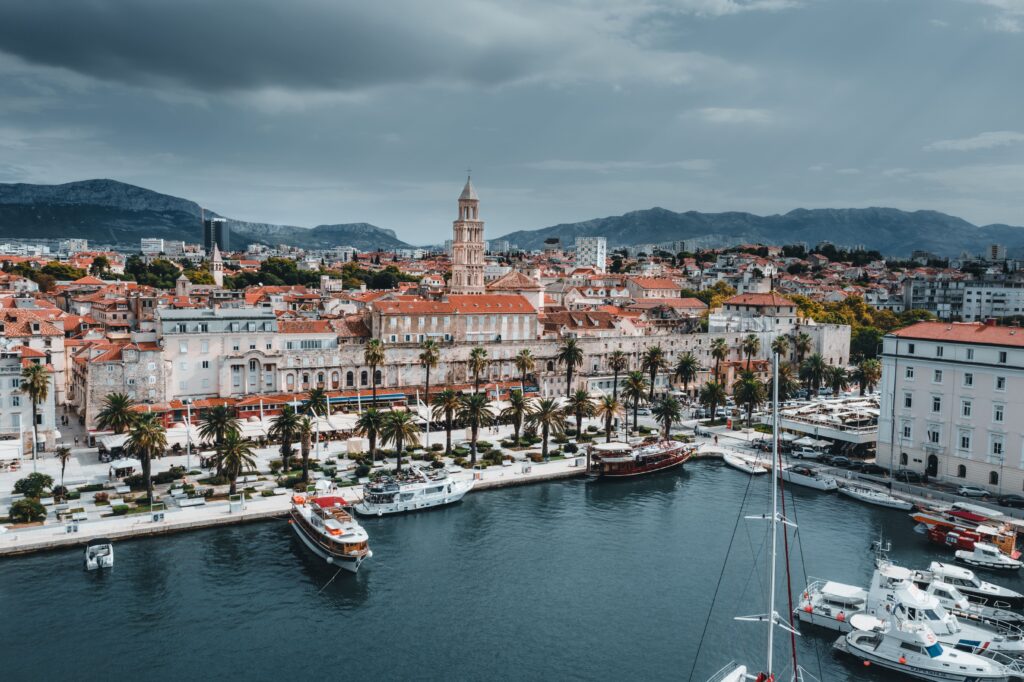 Split Dalmatian Croatia waterfront with historic buildings palm trees boats and mountains